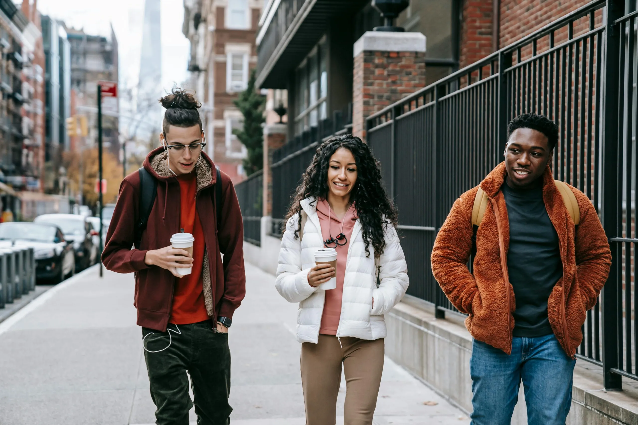 Budget Van Rental NYC in 2025: Your Handy Guide to Hauling Your Crew 2 Young glad multiracial partners with hot drinks to go strolling on urban pavement in daytime
